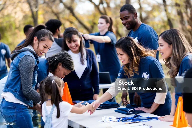 An image of a family signing up to volunteer at a table.